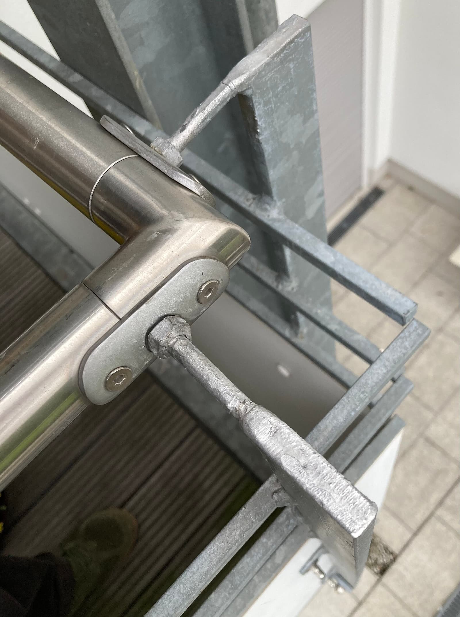 Railing hardware where the fastener alloy is the first thing to stain